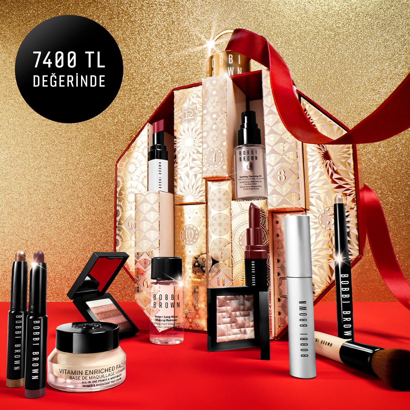 The 2023 Bobbi Brown Advent Calendar, revealing some of the product contents, decorated with a luxury red ribbon
